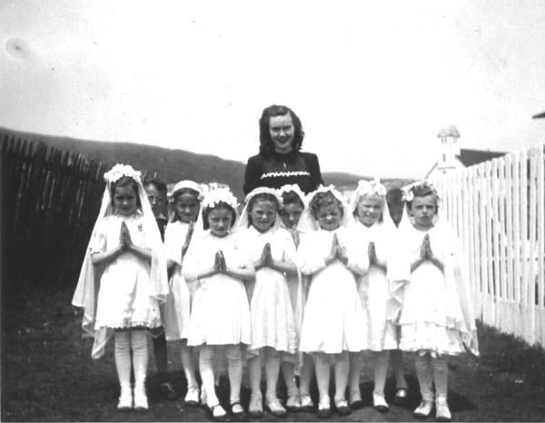 031: Cede McCarthy with First Communion group. l-r Mary Reddy, Vince Carroll, Mary Ennis, Teresa Norman, Kathleen  Barry, Mary Finn (center), Betty Whelan, Madonna McCarthy, unknown, Noreen Ryan. (circa 1946)  - Mary daughter of Michael Reddy &amp;amp; Elizabeth Moore; Vince son of Michael Carroll &amp;amp;  Josie Barry; Mary daughter of Vincent Ennis &amp;amp; Min Carroll; Teresa daughter of Peter Norman  &amp;amp; Marg Norman; Kathleen daughter of Thomas Barry &amp;amp; Anne Dollimont; Mary daughter of  Patrick Finn &amp;amp; Lena Hayward; Betty daughter of William Whelan &amp;amp; Mary Bridget Carroll;  Madonna daughter of James McCarthy &amp;amp; Mary Ellen Barry; Noreen daughter of Albert Ryan &amp;amp;  Catherine Nolan.